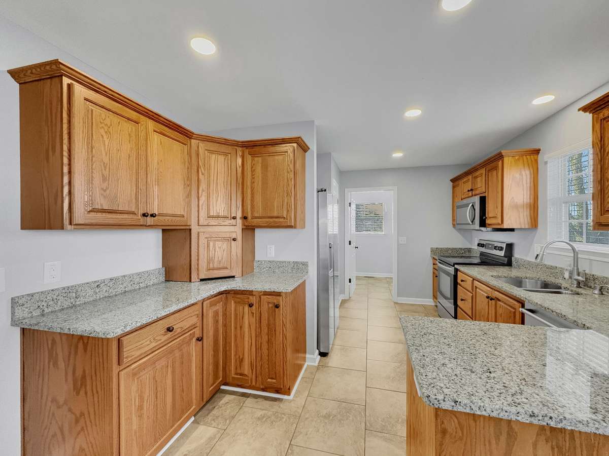Bright kitchen with additional cabinets, plenty of counter top space.