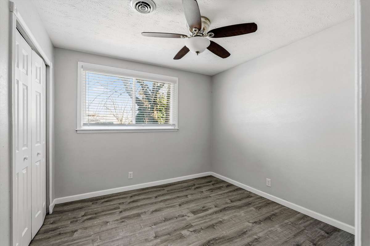Down the hallway is a secondary bedroom, perfect for a nursery or home office.