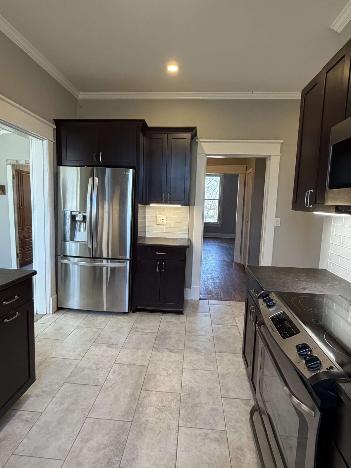 Coffee bar to the right of the refrigerator