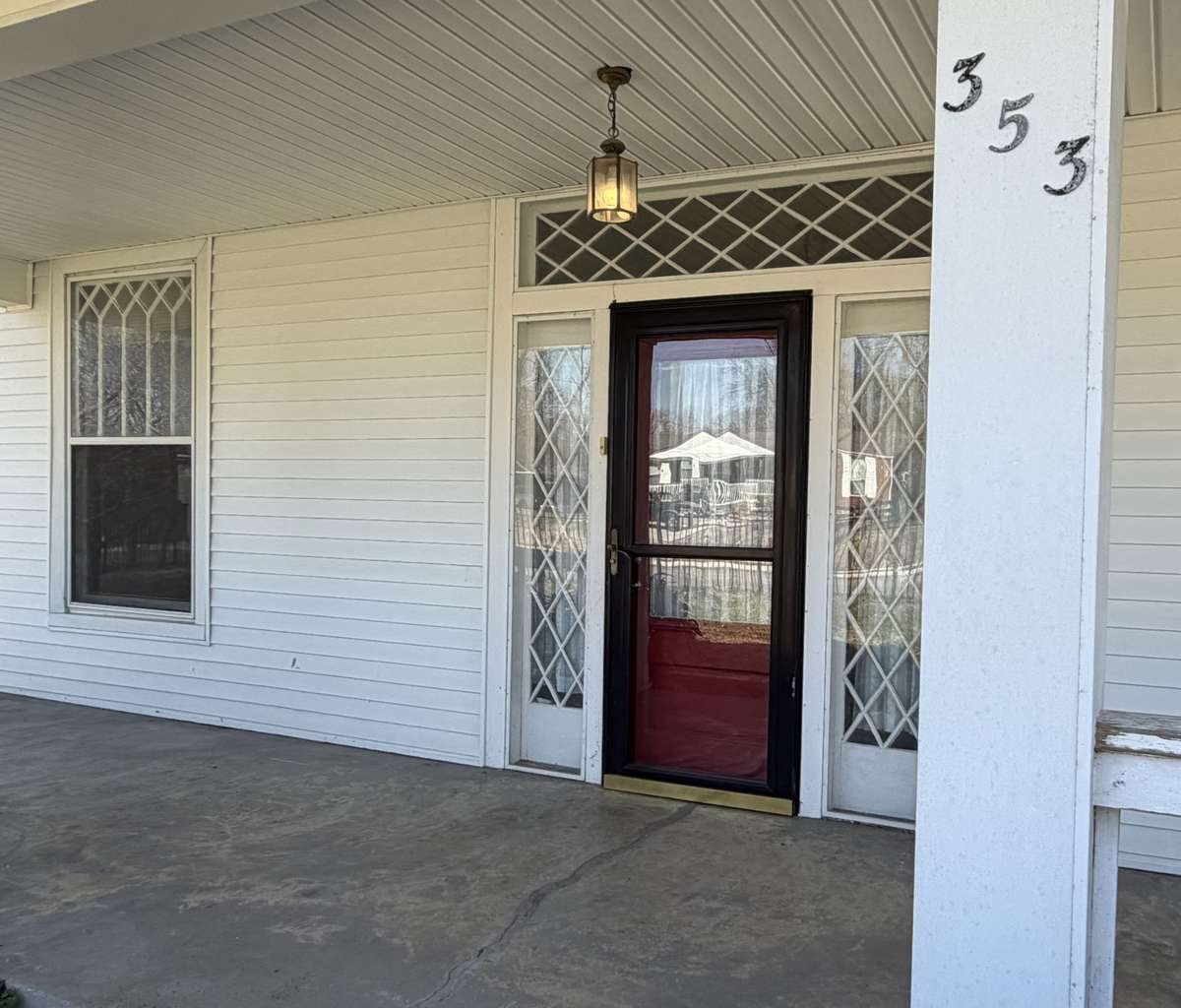 The original, intricate window detailing highlights the home's heritage and provides a timeless elegance to the entry.
