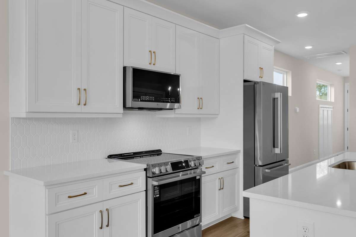Another view of the upgraded appliances, quartz countertops and qualify cabinetry.