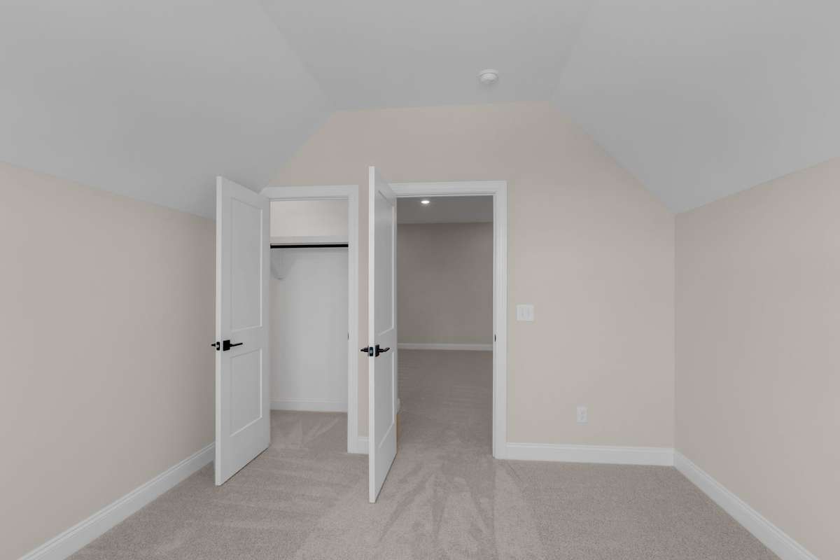 Upstairs bedroom 3 that has great ceilings that make the space feel larger and open.