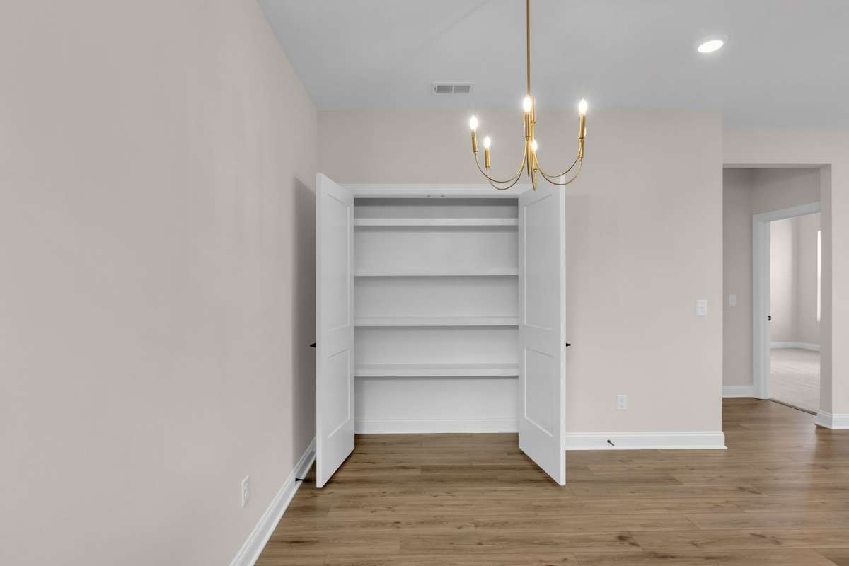Double door pantry in your dining area with wood shelving to hold all your favorite dried food and sweet treats!