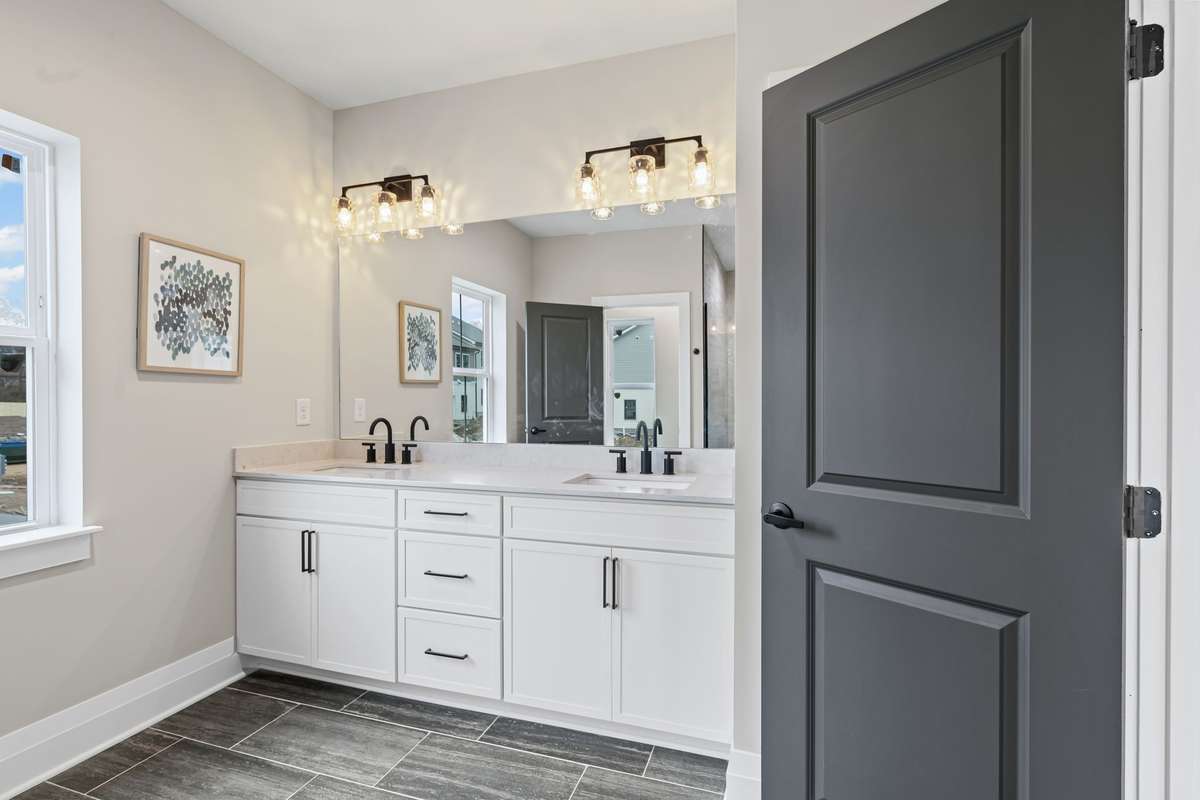 Double Vanities in Primary Bath with Custom Cabinets and Shelving.