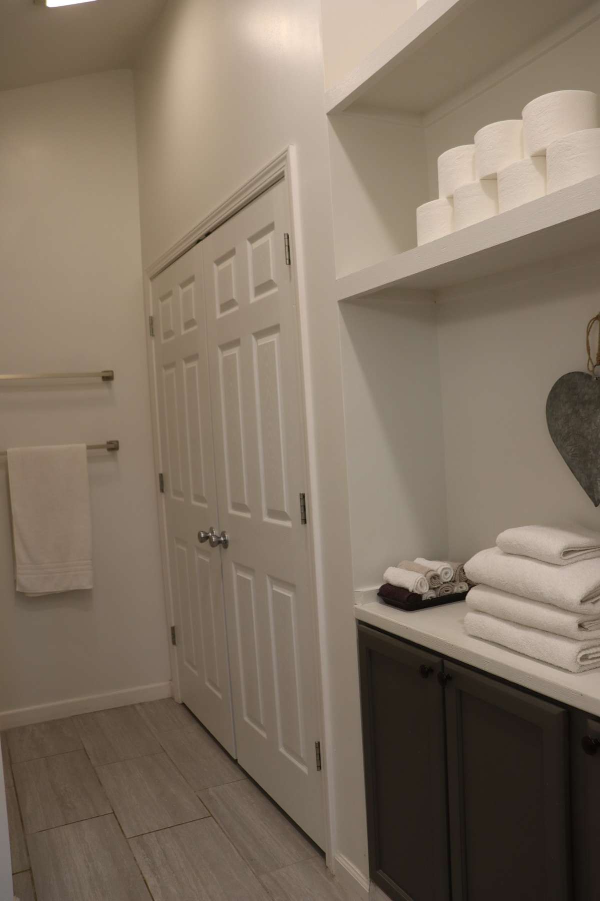Your washer and dryer connections are tucked away behind these double doors. The shower/tub combo is across from the laundry.