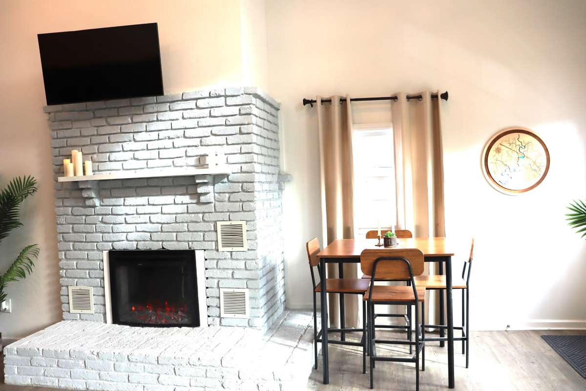 An electric fireplace adds ambience to your home. Dining is available for family and friends at the dining table.