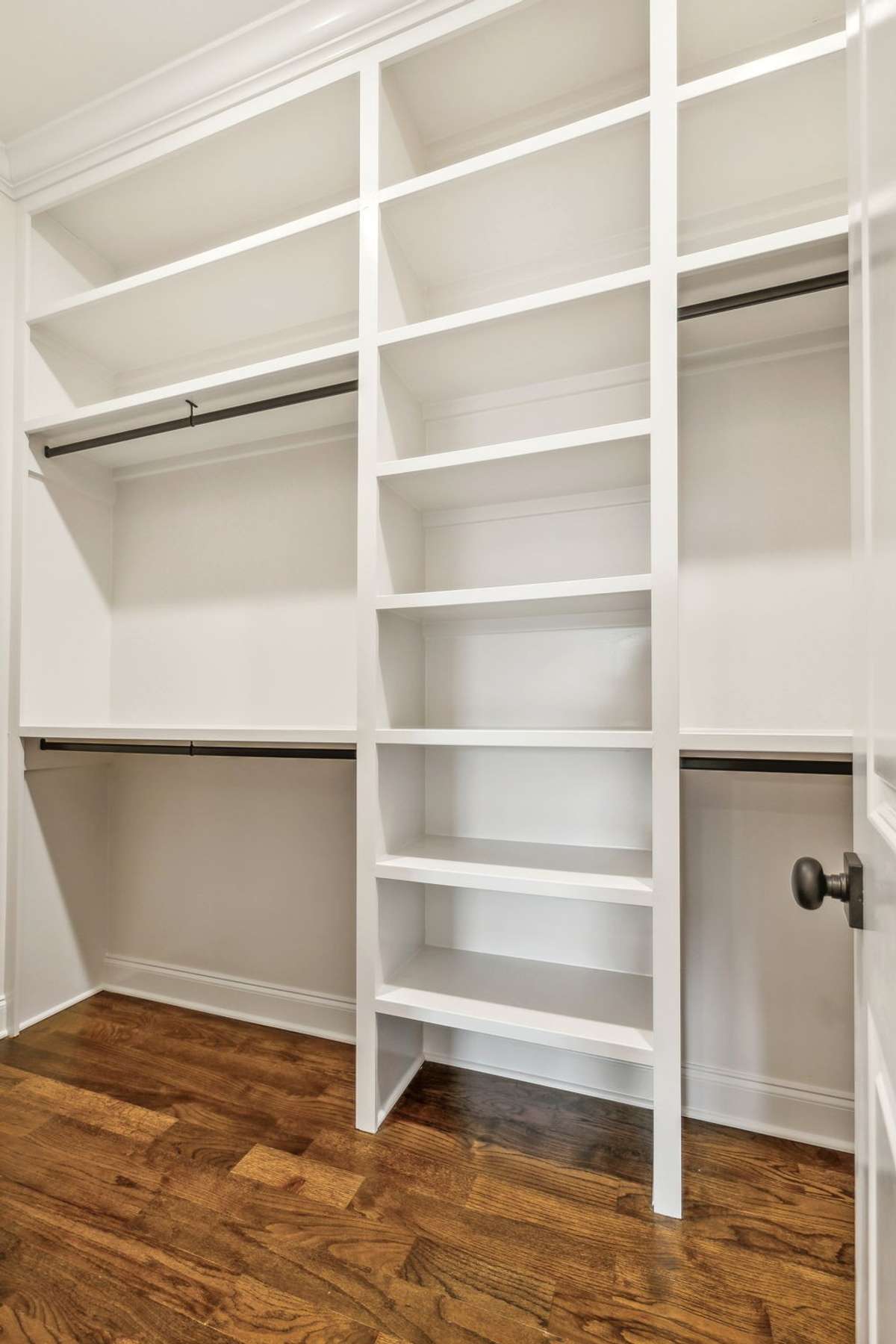 Primary closet features custom built-ins
