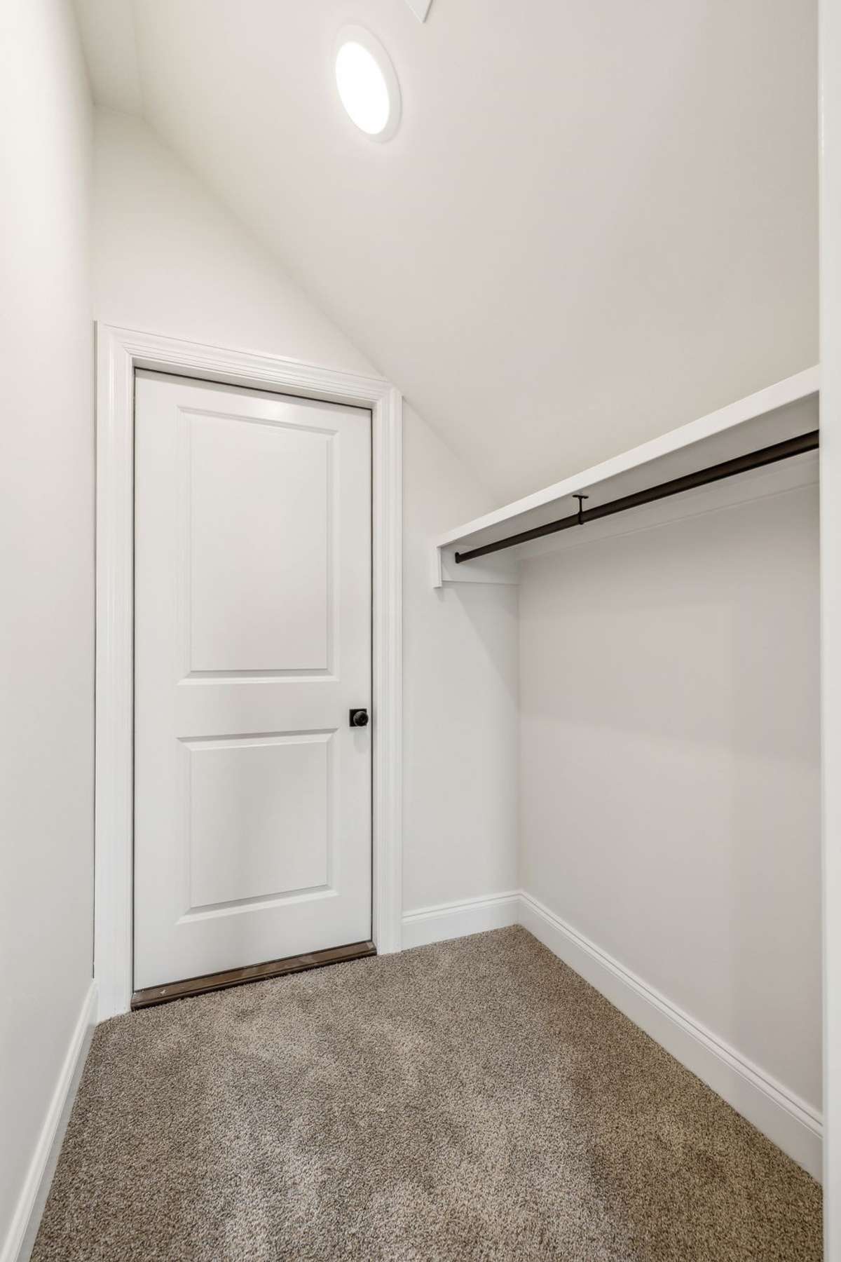 Closet off bonus room has door to floored walk-in attic space.