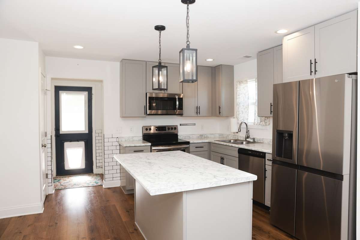 Kitchen with Island seating, back door (with dog entry) leads to large fenced backyard