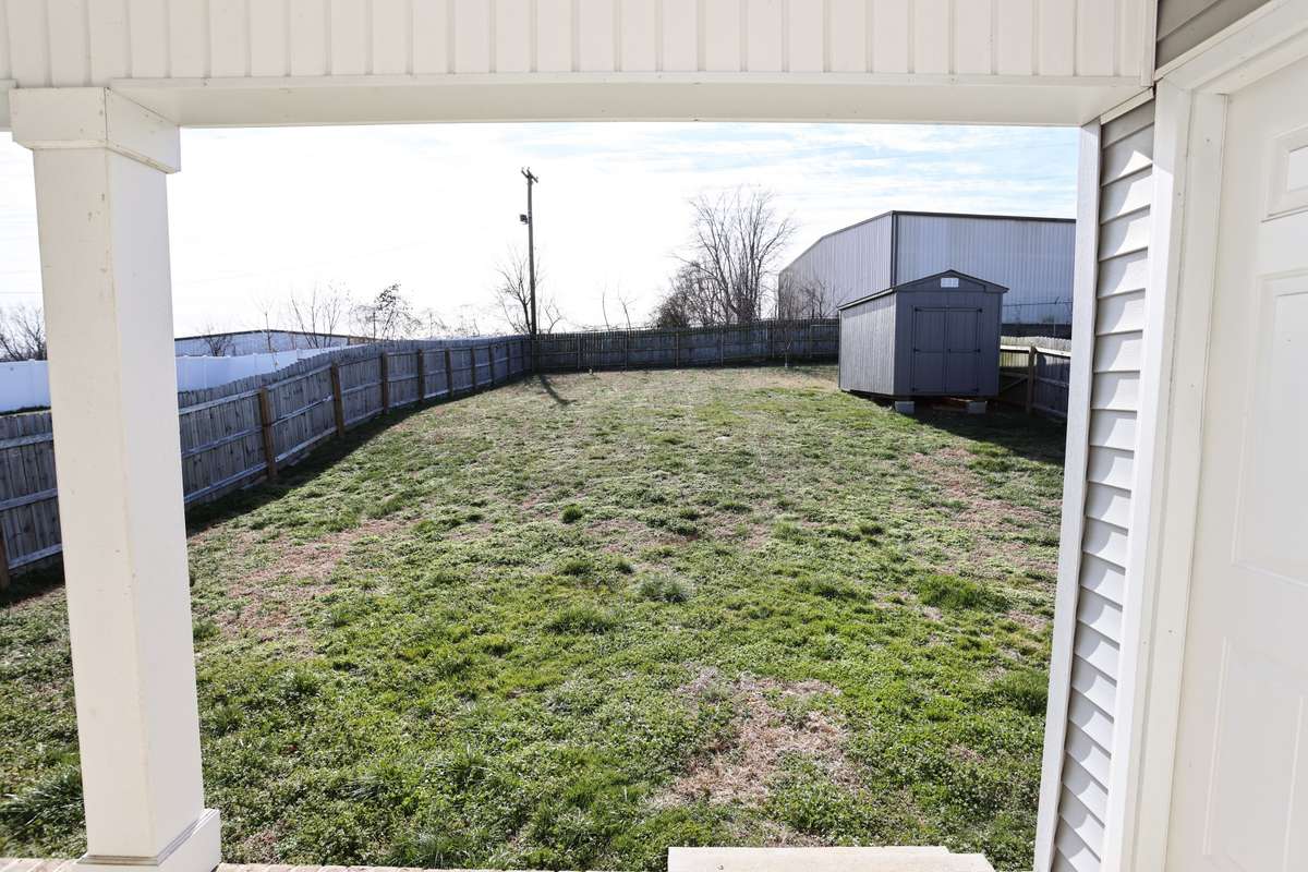 Fenced Back Yard with Storage Building