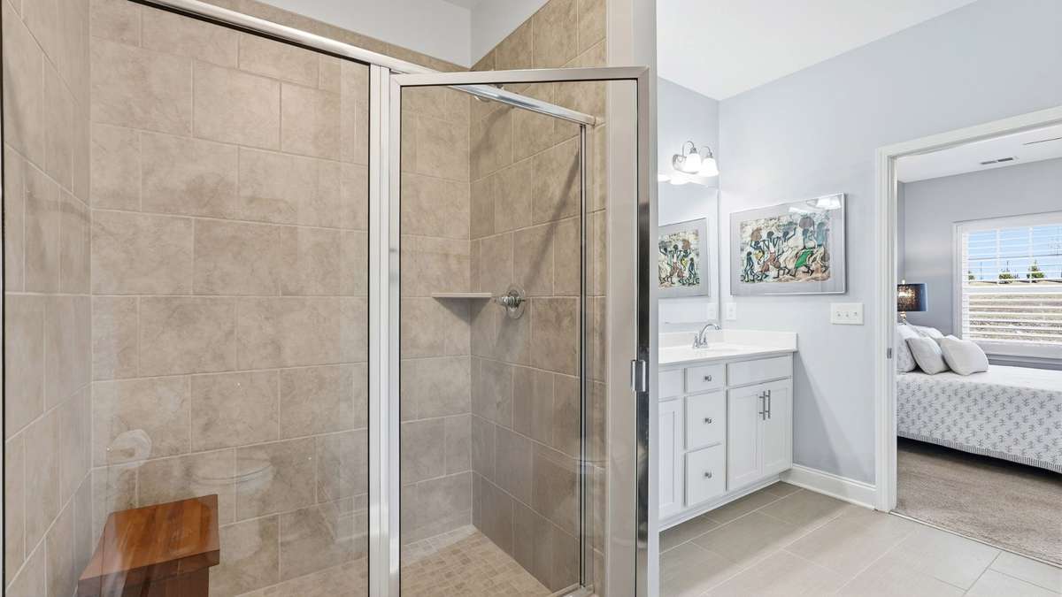 Primary bathroom with large 5 ft tiled shower.