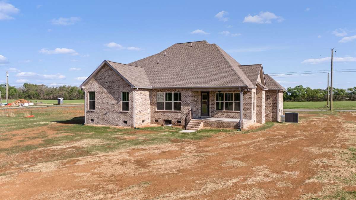 Covered porch leads to 8/10 of an acre lot for making wonderful memories.