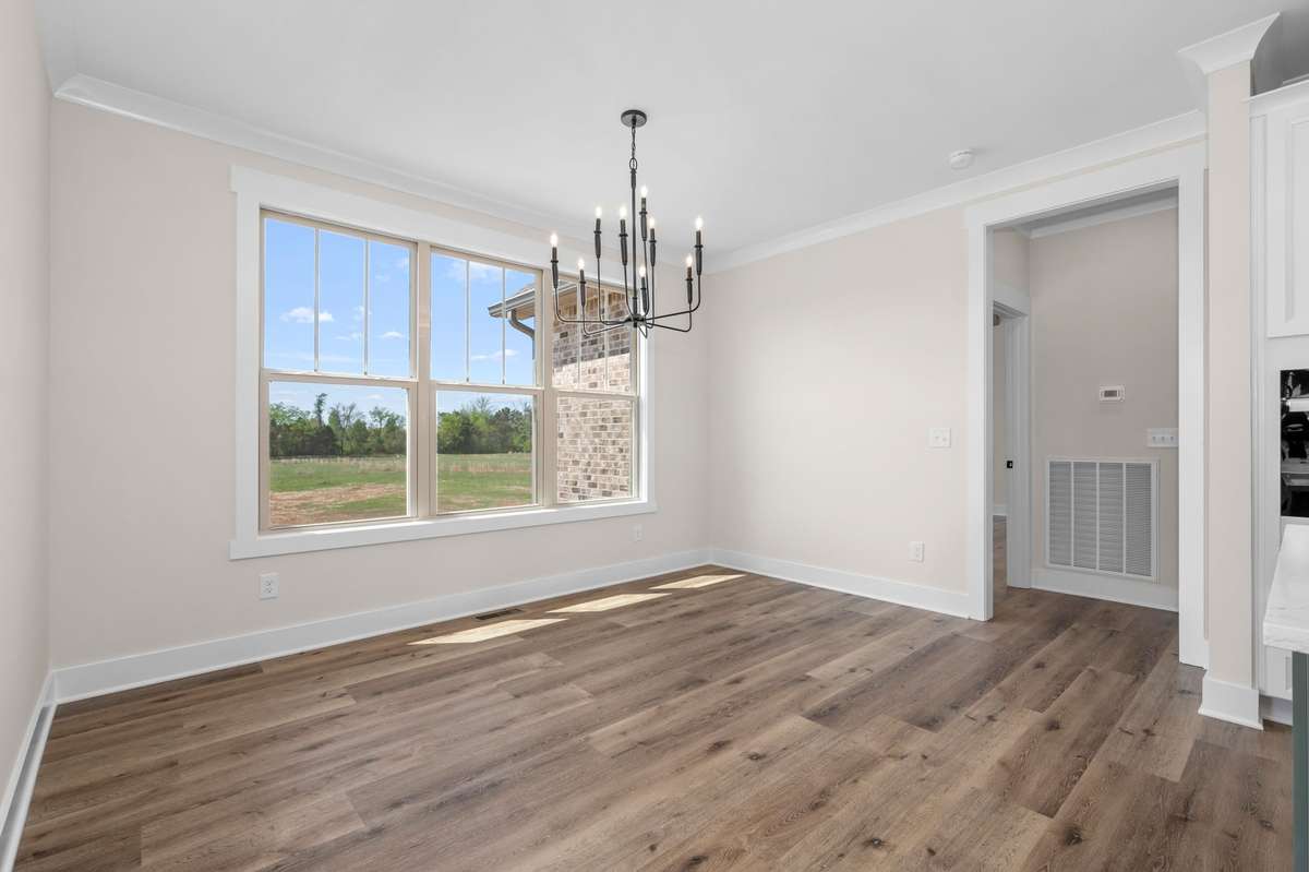 Spacious breakfast area with triple windows overlooking huge yard is a great way to start each morning.
