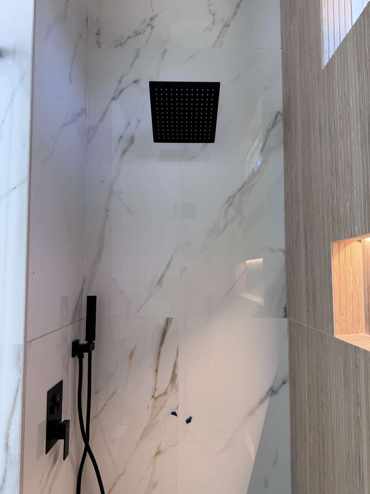 Primary shower tile and fixtures close-up
