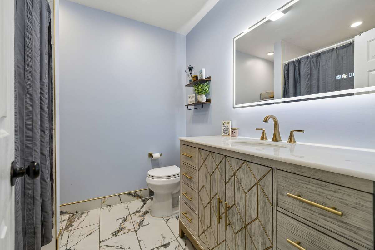 Renovated Guest Bathroom in the Basement with LED Anti-Fog Mirror, Tile Flooring & Tile Shower/Tub Combo