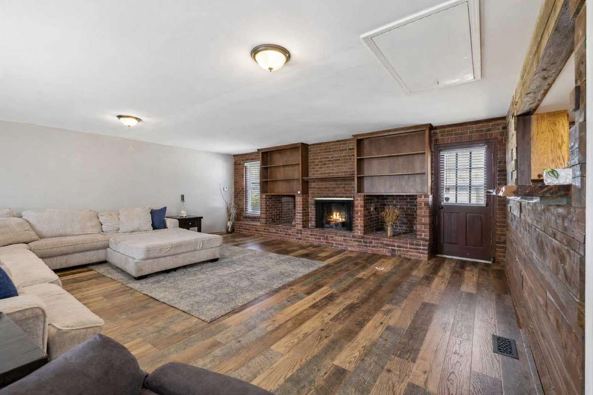 Living Room with Gas Fireplace & Built-In Shelving 

Photo has been virtually enhanced for marketing purposes