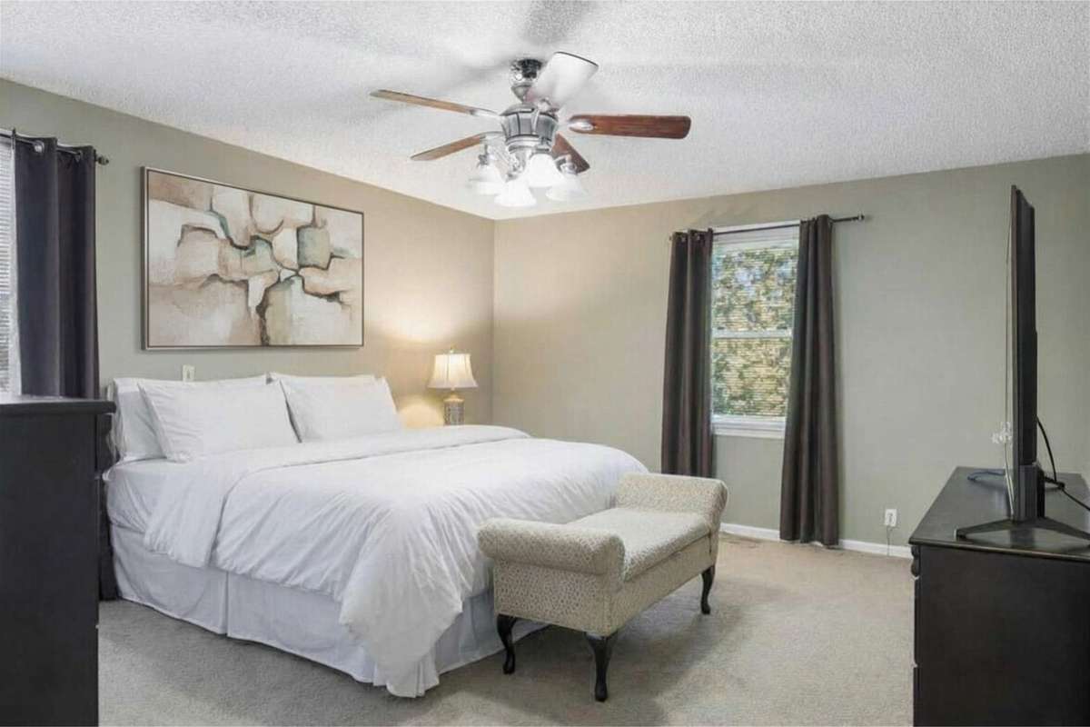 Main Level Primary Ensuite with Ceiling Fan & Walk-In Closet 

Photo has been virtually enhanced for marketing purposes