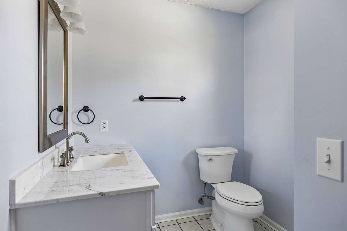 Primary Bathroom with Tile Flooring, Linen Closet & Shower with Glass Door