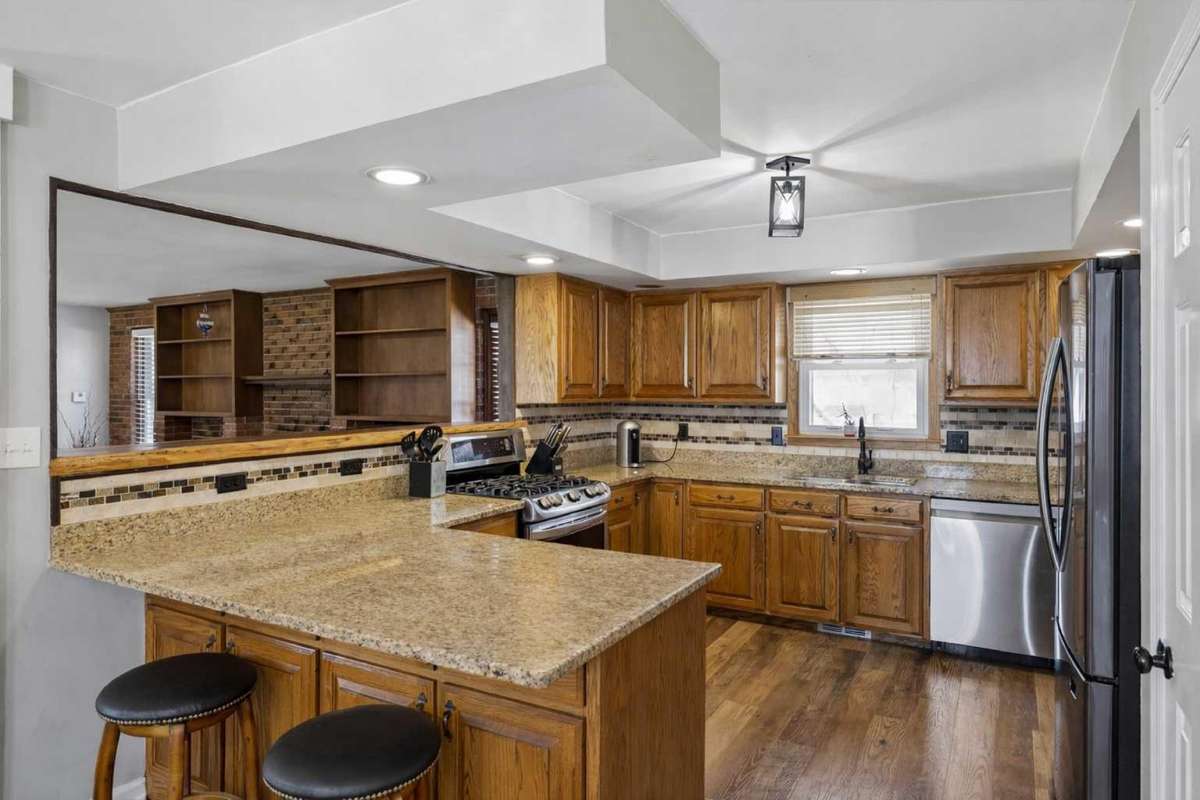 Kitchen with Granite Countertops, Tile Backsplash, Gas Oven, SS Appliances & Pantry 

Photo has been virtually enhanced for marketing purposes