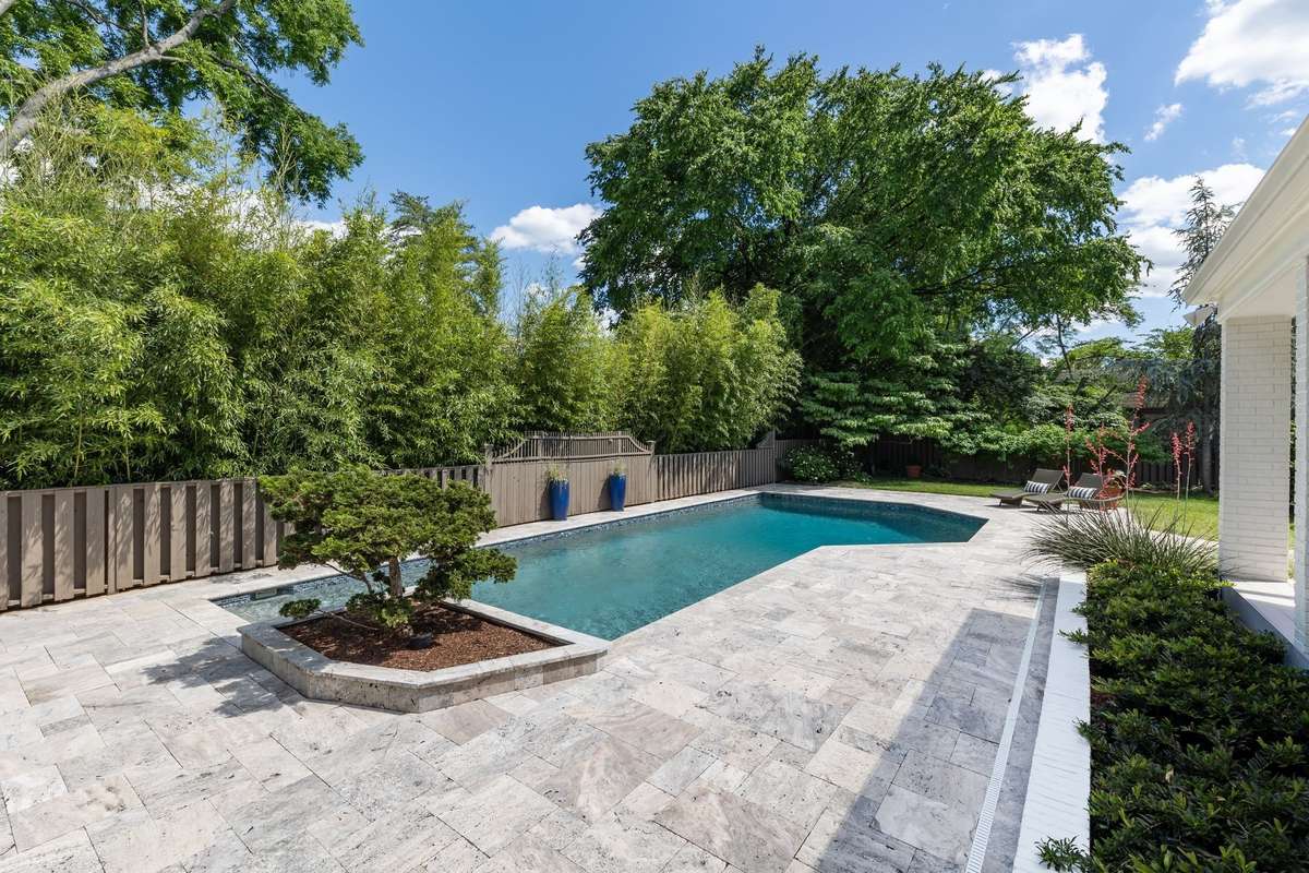 Silver travertine surrounds the pool.