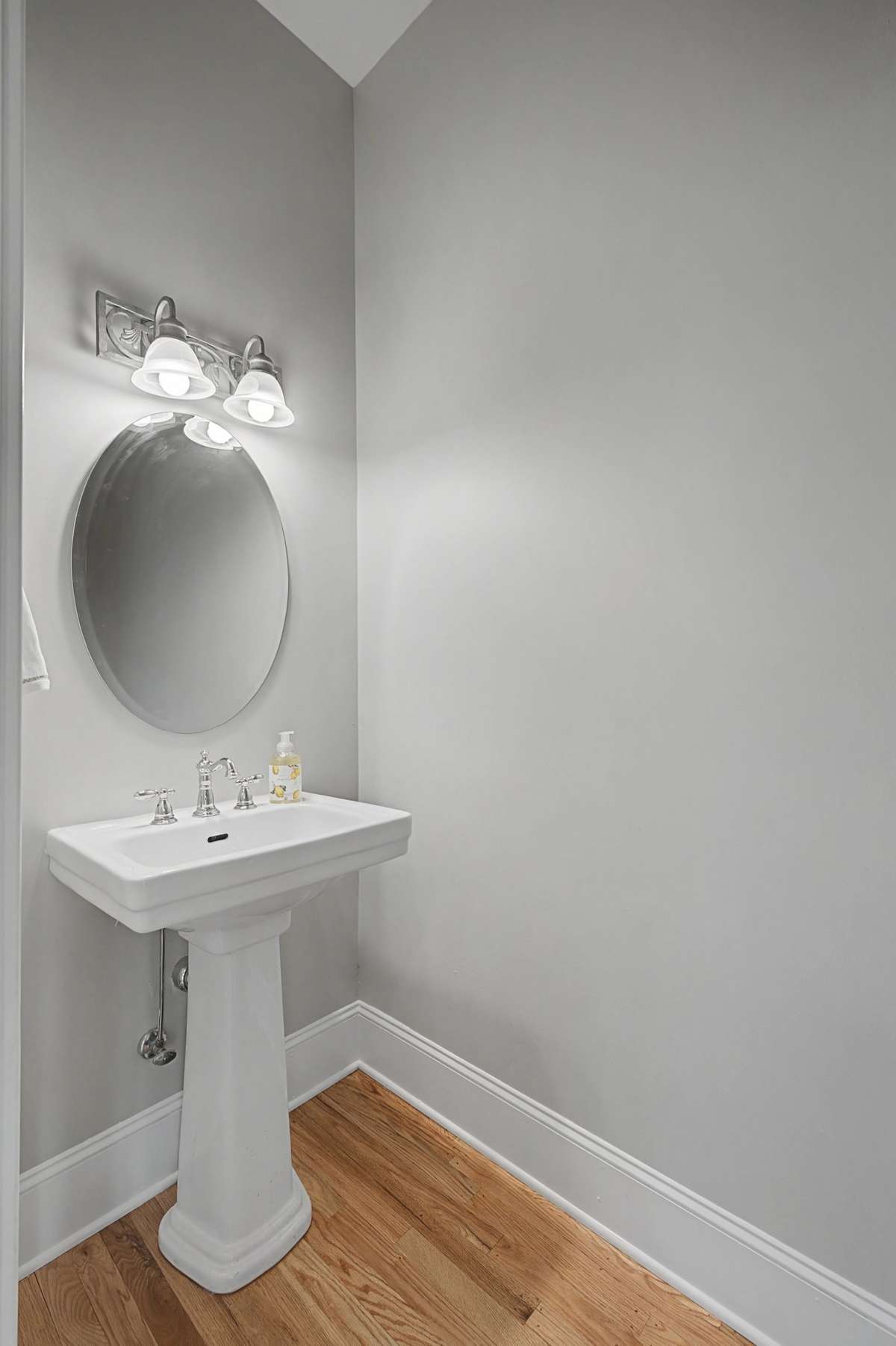 Powder Room: Convenient main-level half-bath with a classic pedestal sink