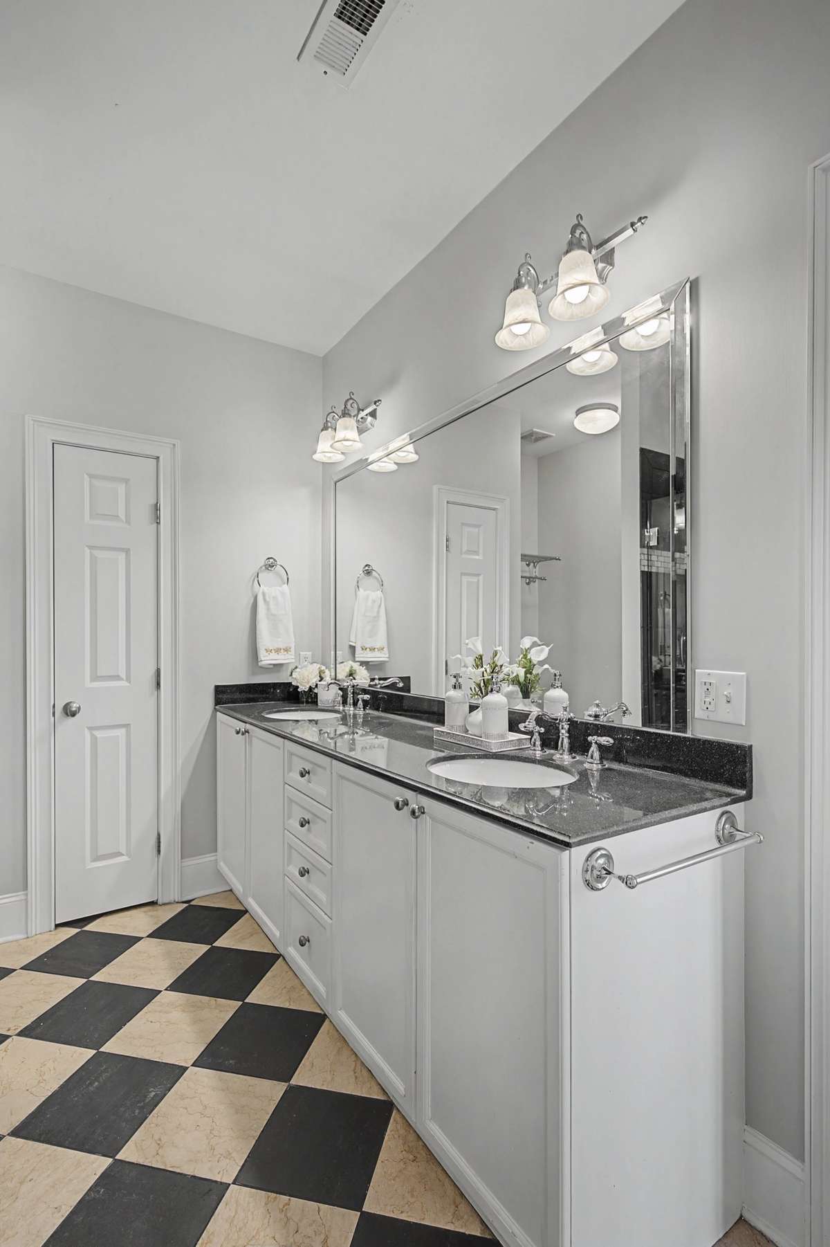 Primary Vanity: Dual vanity with expansive counter space and custom tile flooring