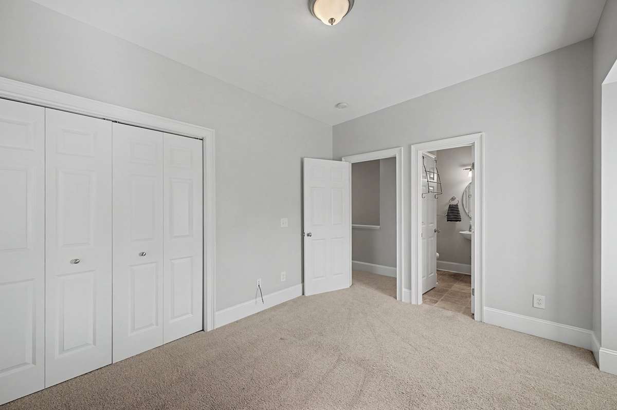 Bedroom 2: Bright secondary bedroom with large closets and clean finishes