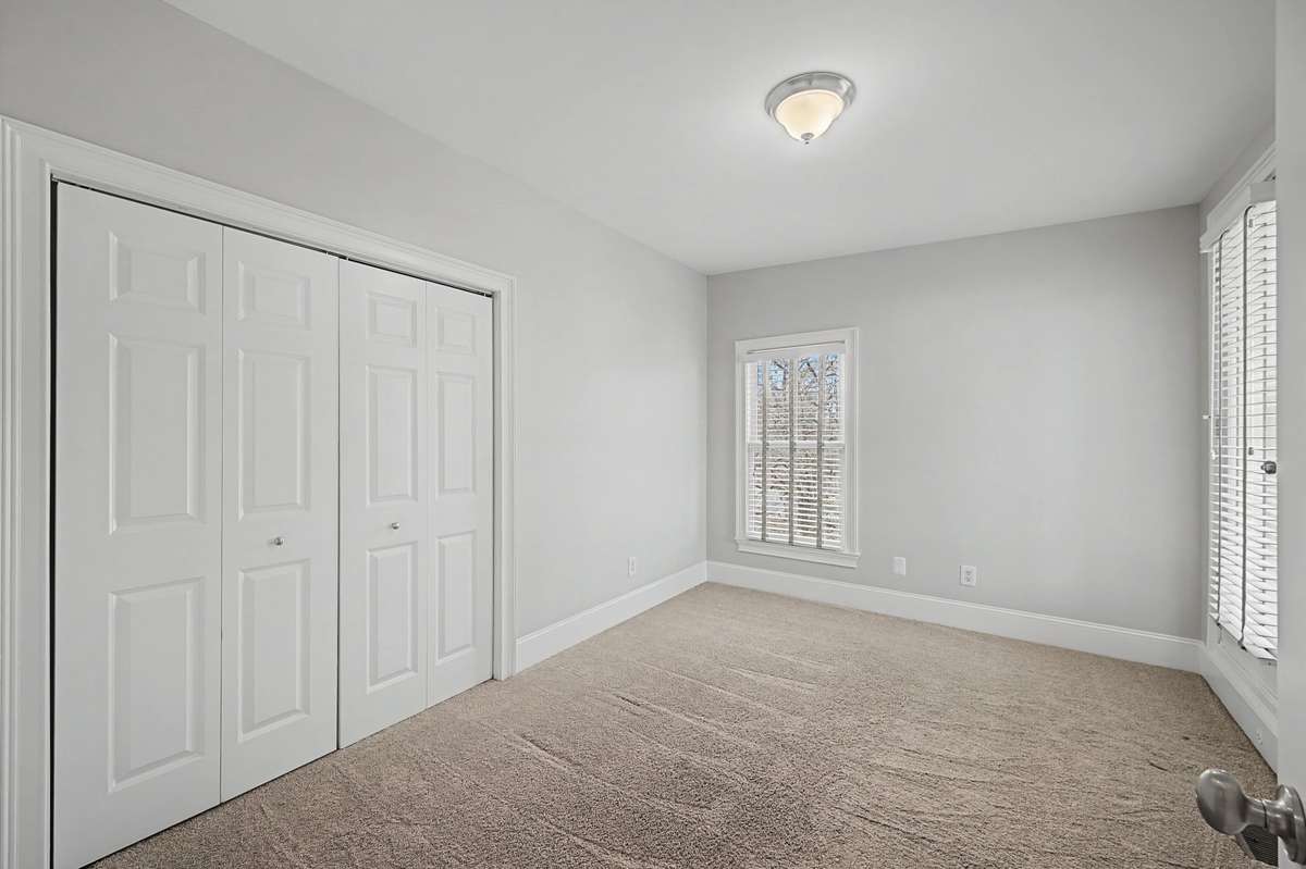 Bedroom 3: Third bedroom offering flexibility for guests or a home office and direct access to the rooftop deck