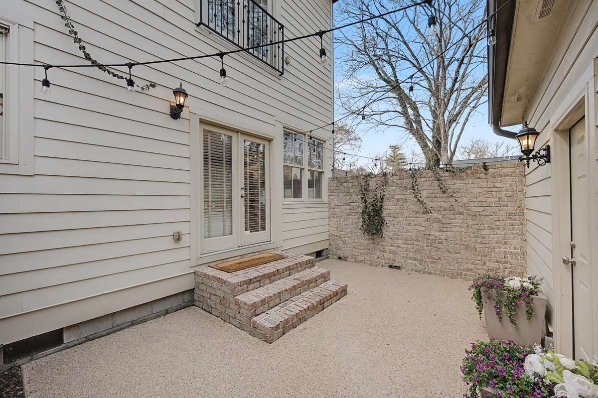 Private Courtyard (Lights): Charming enclosed courtyard with pea gravel and festive string lighting