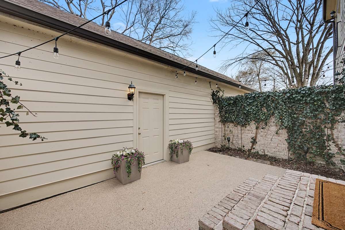 Courtyard (Garage Entry): Secure and private patio area connecting the home to the garage