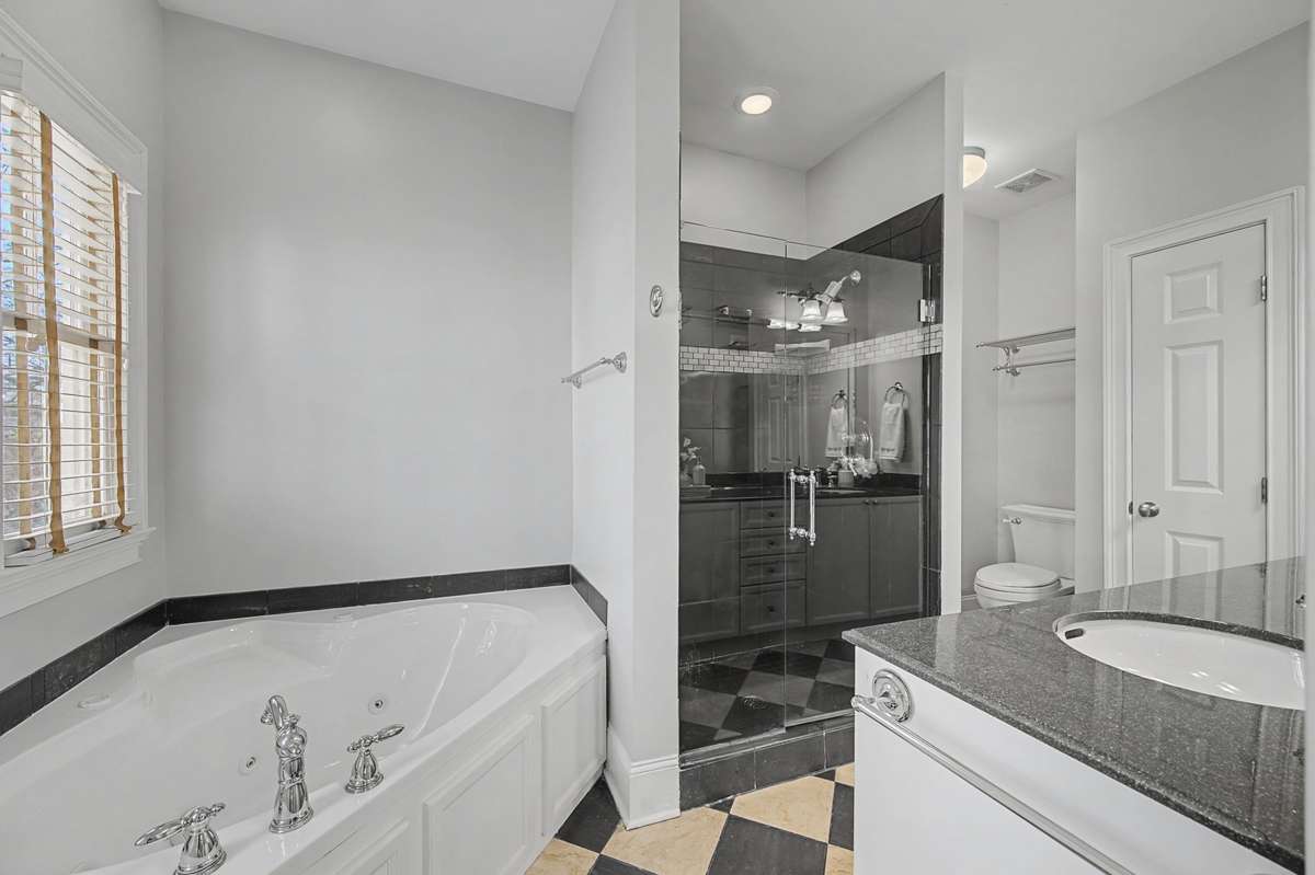 Primary Bathroom (Tub/Shower): Spa-like primary bath featuring a deep soaking tub and separate glass-enclosed shower.