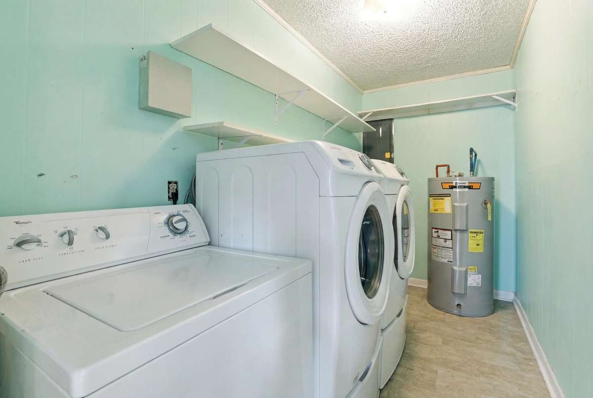 Spacious laudry room with 2 year old water heater. Washer/Dryer to remain.