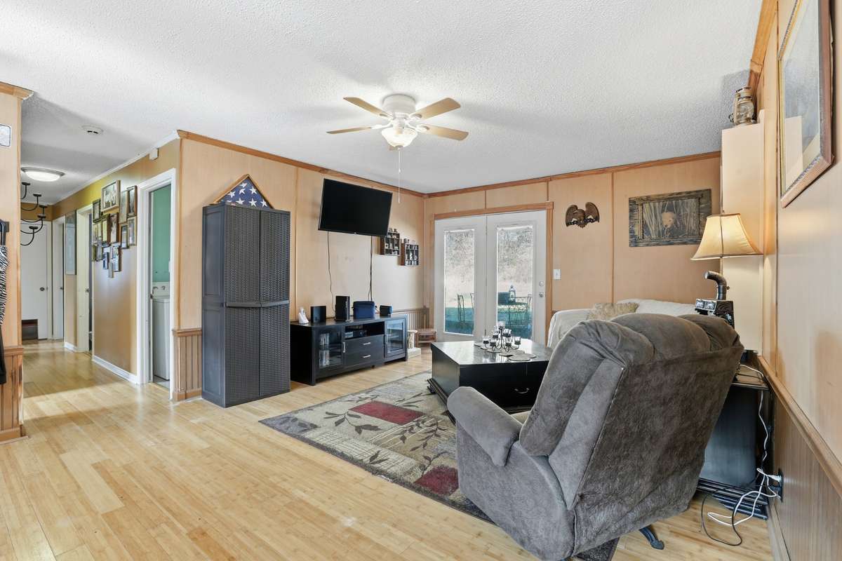 Another view of the Living room with ceiling fan and bamboo floors throughout.