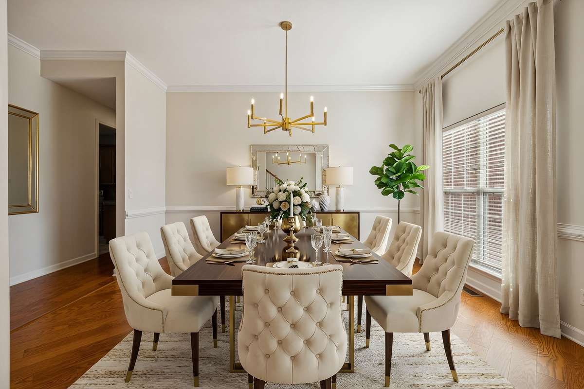 Spacious Dining Room with updated lighting and fresh paint. Virtually staged.