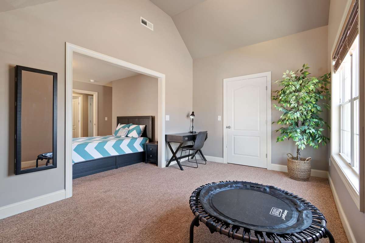 The adjoining space provides flexibility for a sitting area, exercise room, or play space.
