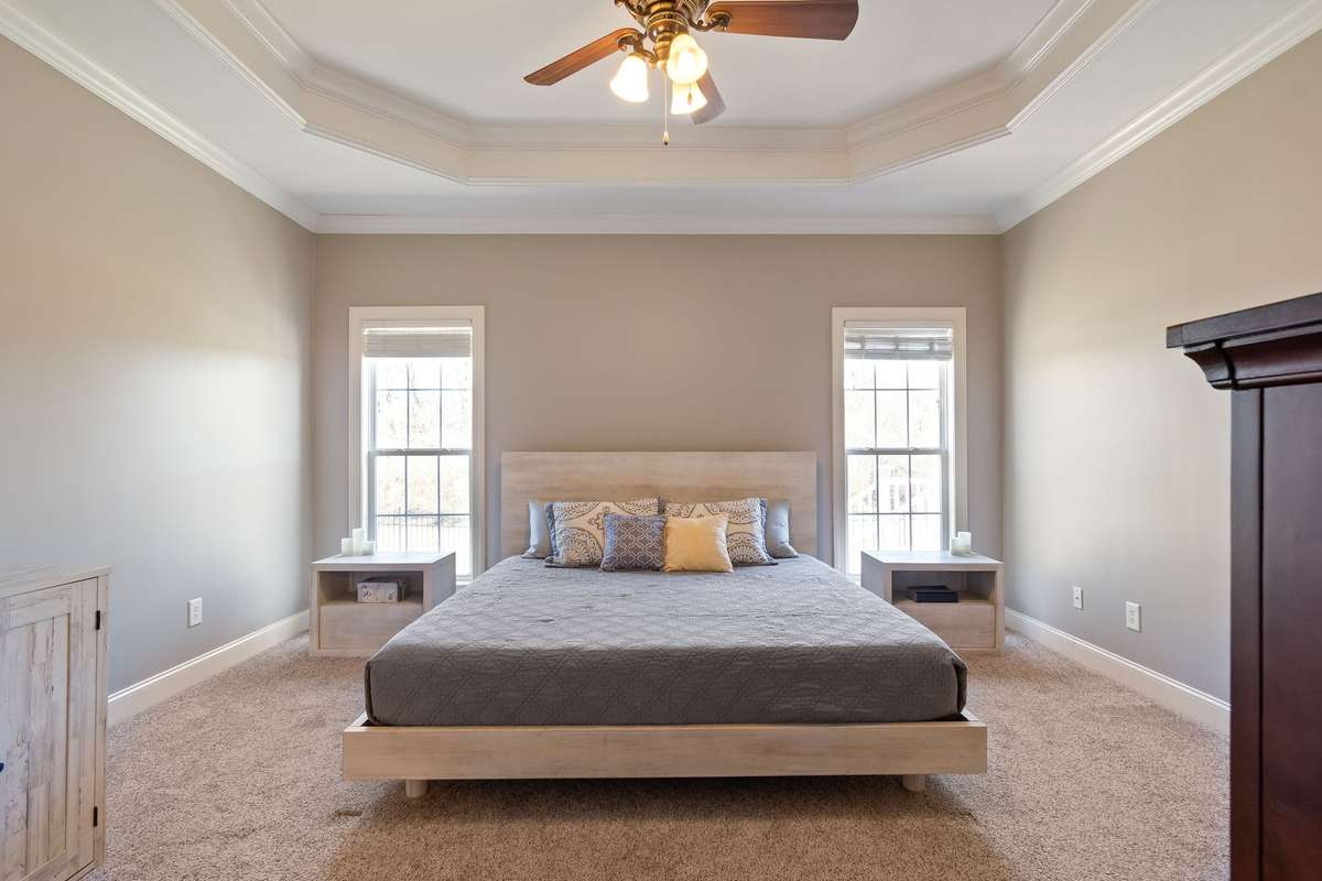 This view of the primary bedroom highlights the spacious layout and natural light.