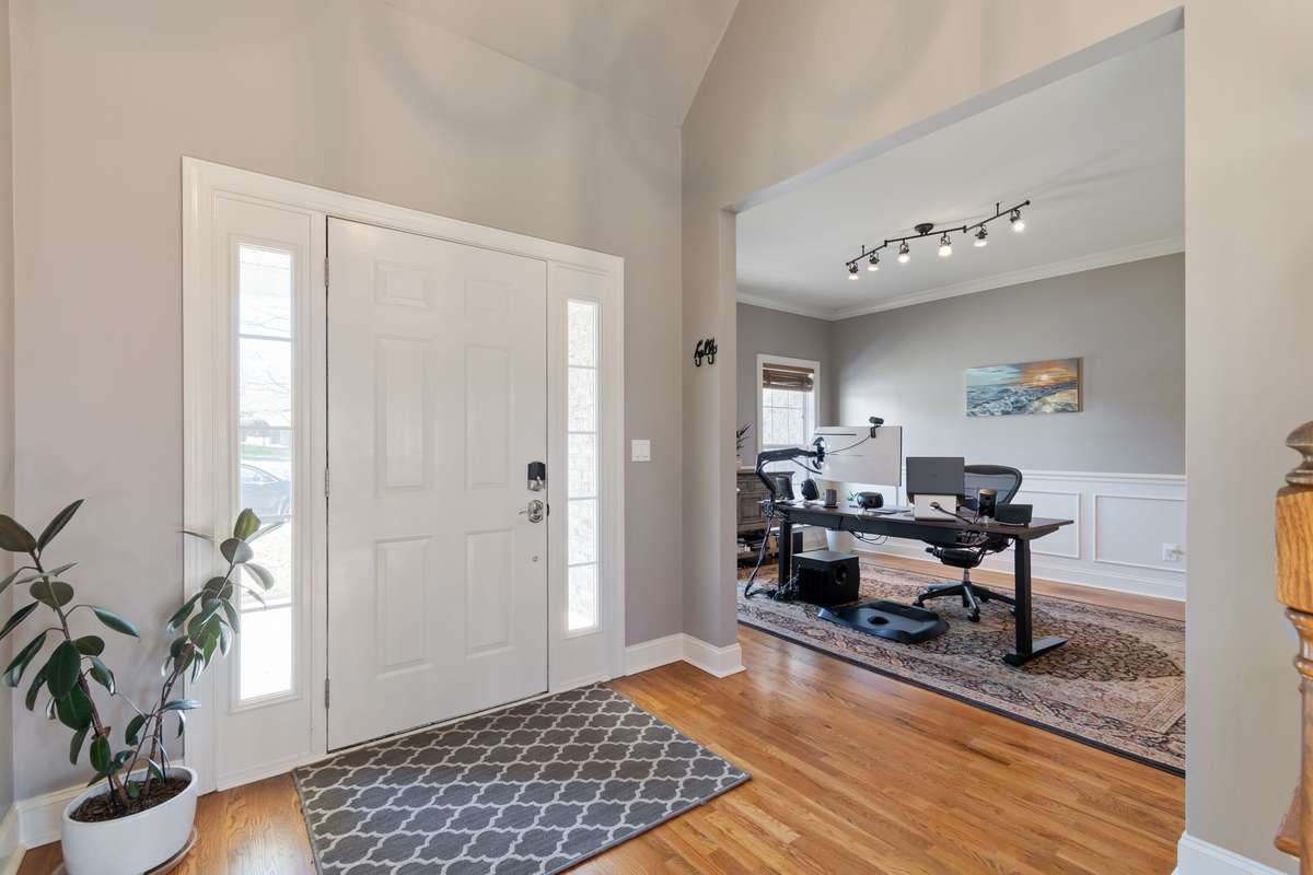 Just off the foyer, the front room offers flexible space suitable for a home office, study, or formal living area.