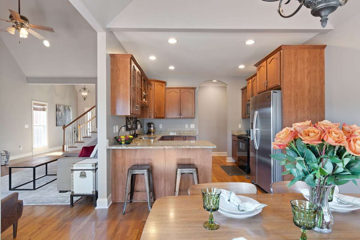 This dining space offers a comfortable layout with easy access to both the kitchen and living room.