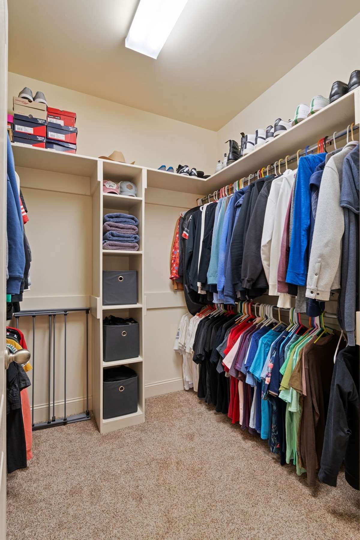 The walk-in closet includes custom shelving, hanging space, and overhead lighting for easy organization.