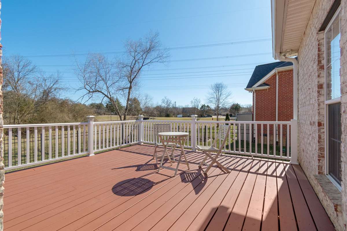 Enjoy the expansive rear deck with wood decking and a durable solid-color stain, complemented by low-maintenance vinyl railing and solar lighting.