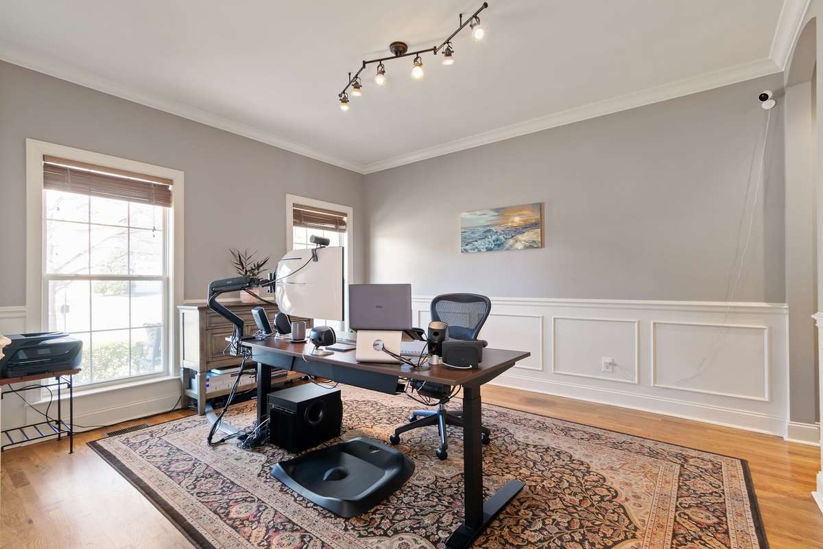 This spacious front room features hardwood floors, crown molding, and abundant natural light.