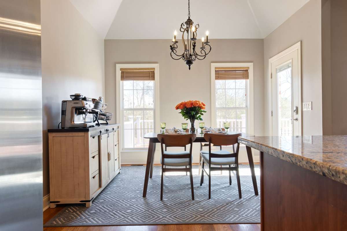 Large windows in the dining area provide abundant natural light and views of the backyard.