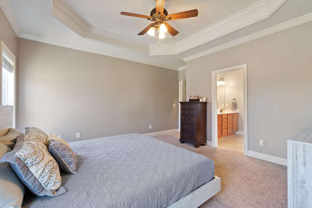 The spacious primary bedroom easily accommodates a king-size bed and additional furnishings.