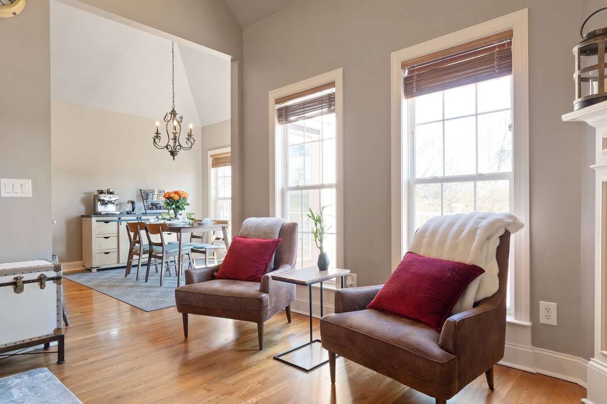 A cozy seating area near the windows offers a perfect spot for reading or relaxing.