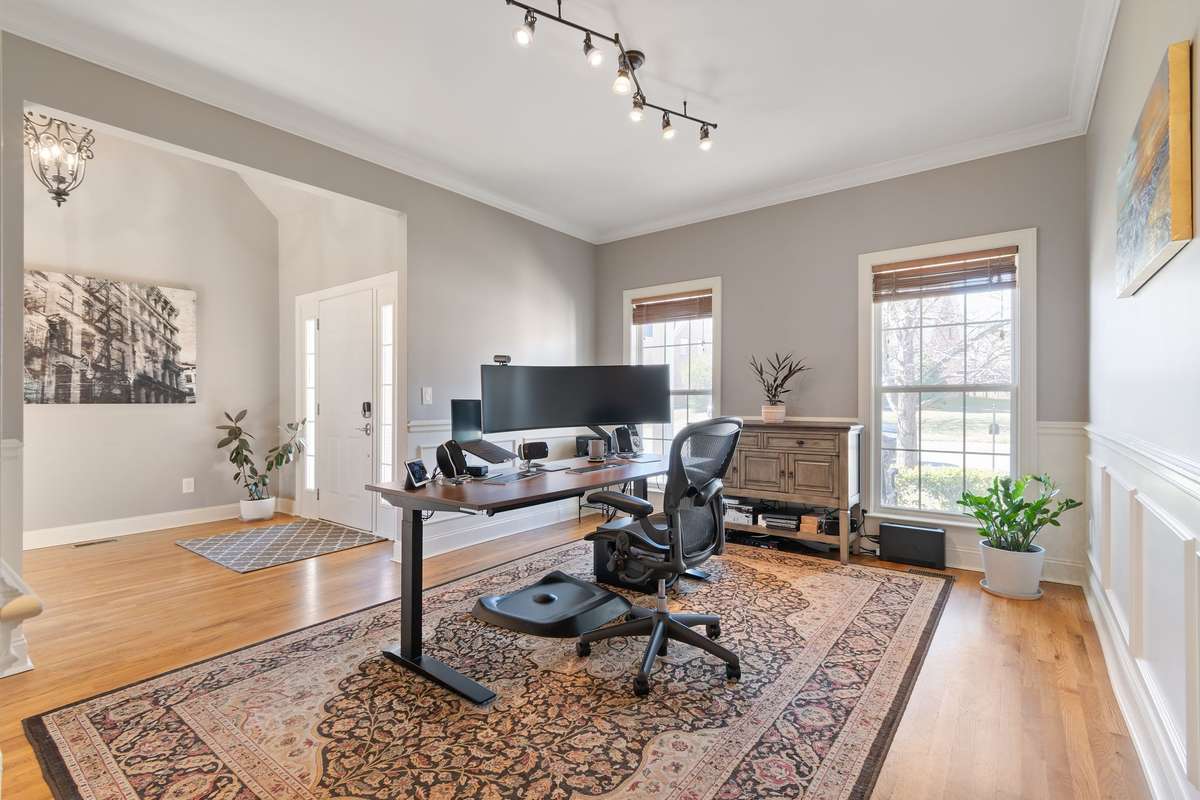 A wide-angle view highlights the room’s generous size and flexible layout for office, living, or formal seating.