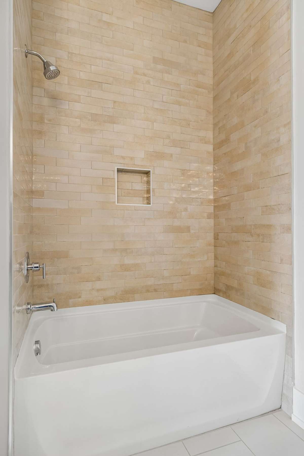 Upstairs Hall Bath and shower combo with tile to the ceiling
