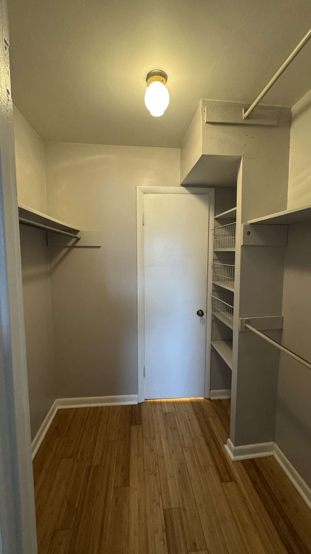 Walk-in / Walk-Thru Closet with multiple hanging rods and built-in shelving.