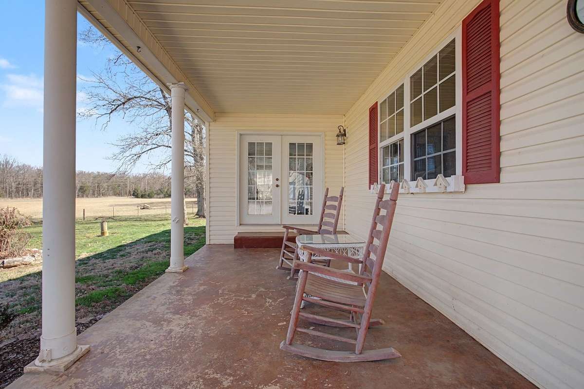Rocking chair front porch overlooking peaceful front yrd
