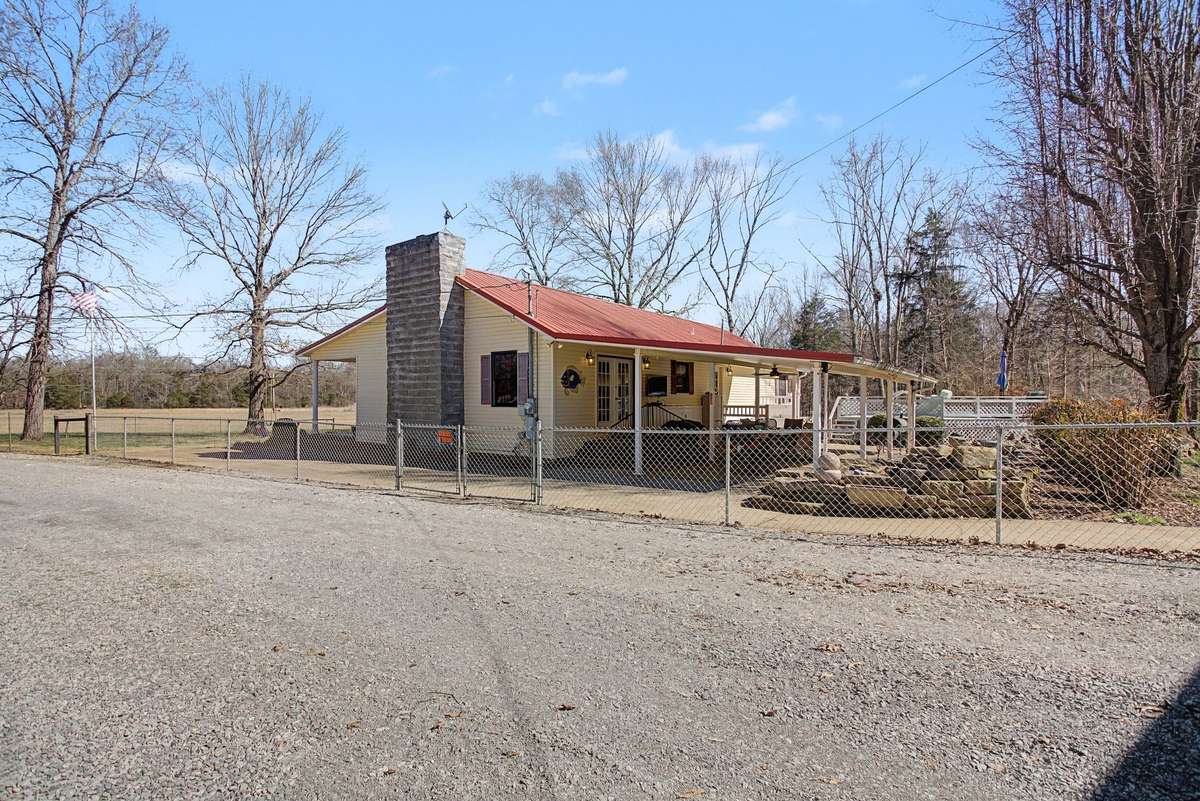 Back view of house from the driveway and extra parking area