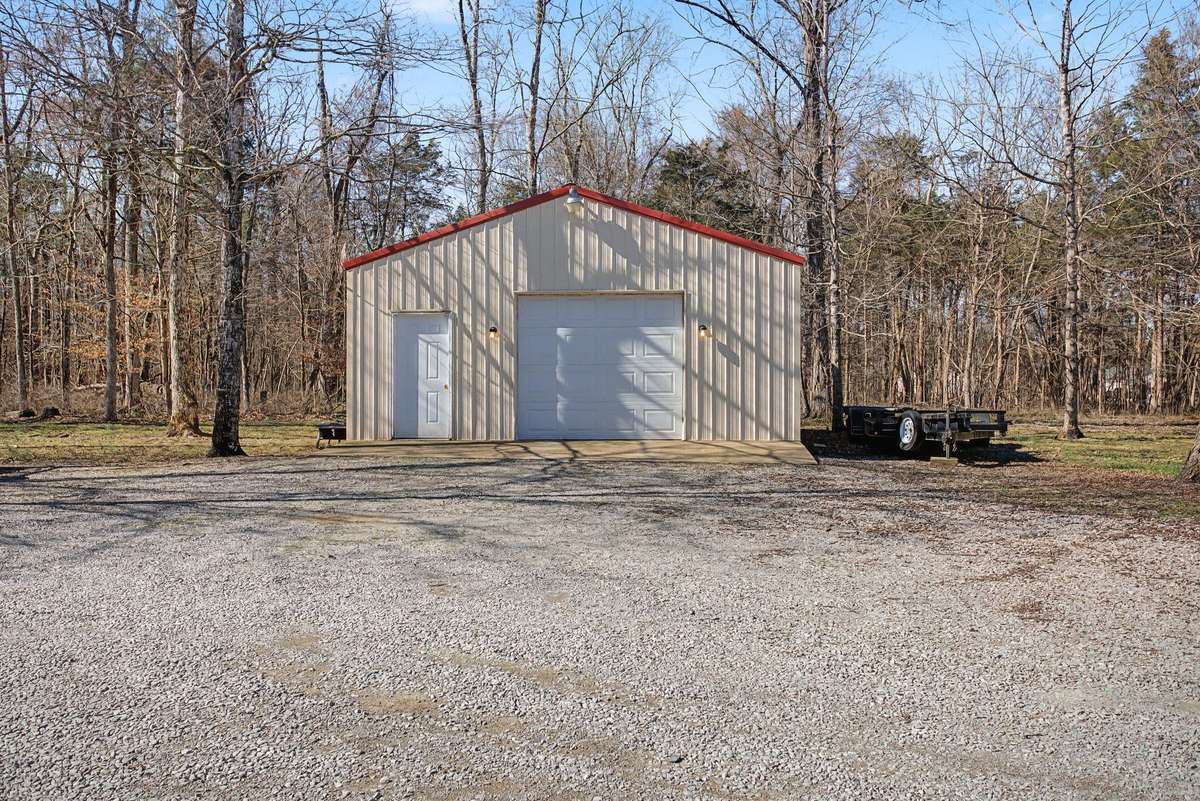 Detached storage barn/shop with electricity, pedestrian door and overhead door entrance
